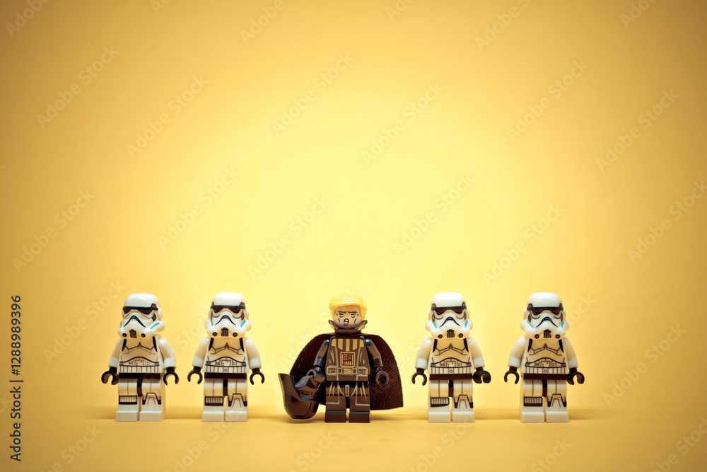 Obraz premium Four stormtroopers are standing in a line with Darth Trump leading them on a yellow background. Illustrative editorial. January 20, 2025