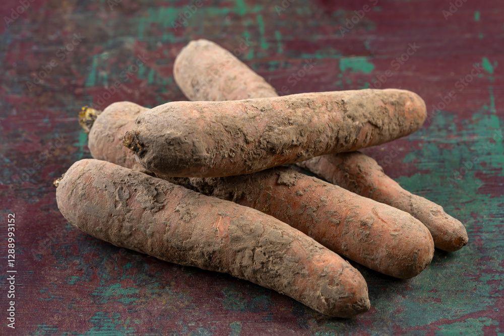 Freshly harvested root vegetables on rustic table Freshly harvested root vegetables on rustic table