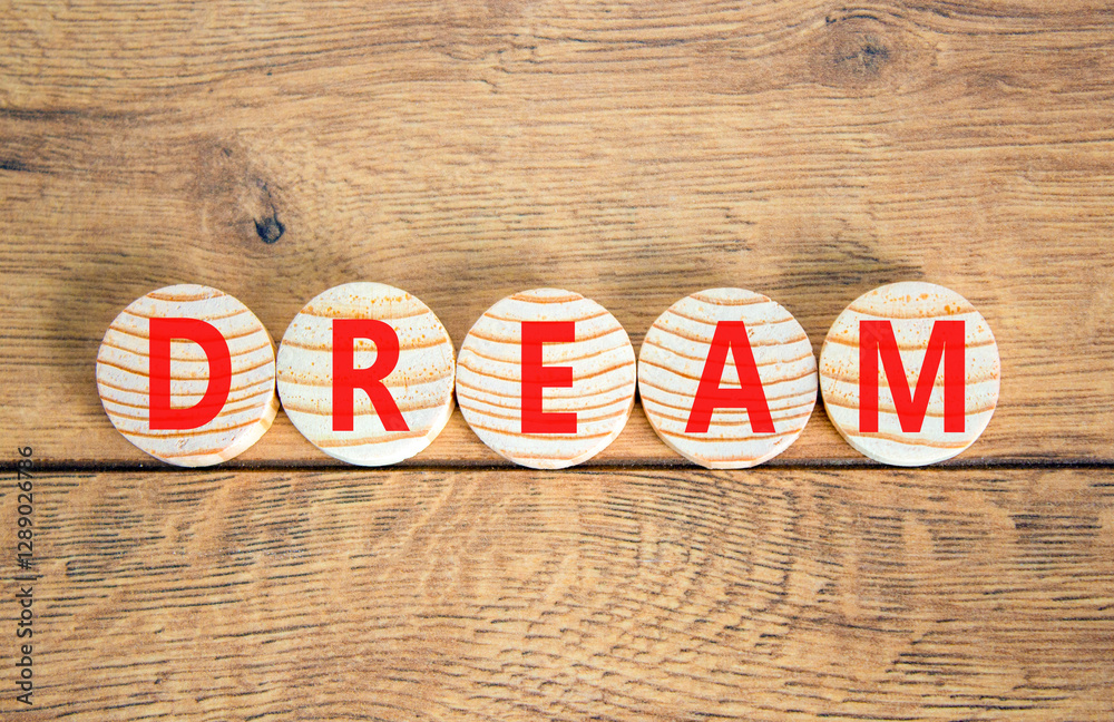 Fototapeta premium Dream symbol. Concept word Dream on beautiful wooden circles. Beautiful wooden table wooden background. Business lifestyle dream concept. Copy space.