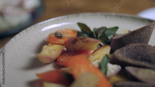 A close-up of a finished dish. This is veal with root vegetables and sage