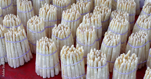 white asparagus tips in bunches for sale at the produce market