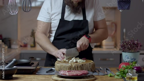 Chef close-up preparing beef with root vegetables. cooking process