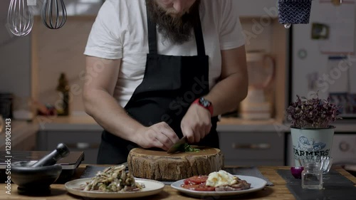 Chef close-up preparing beef with root vegetables. cooking process