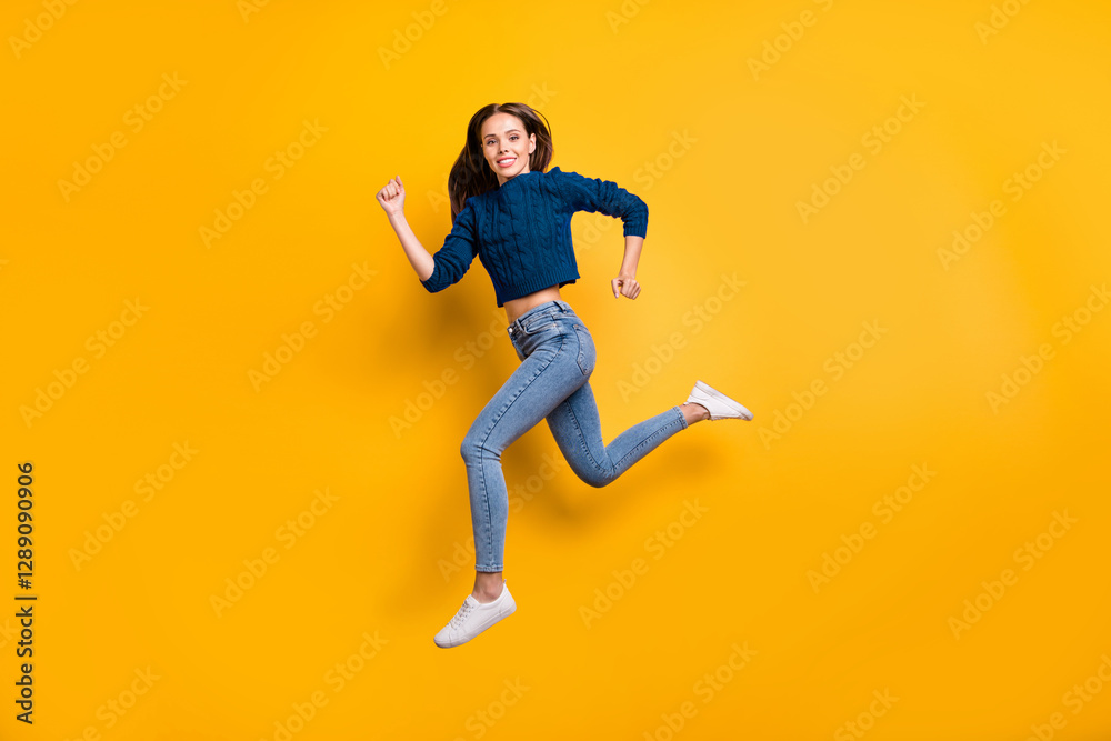 Full size profile side photo of lovely youth running in maroon pullover isolated over yellow background Full size profile side photo of lovely youth running in maroon pullover isolated over yellow background