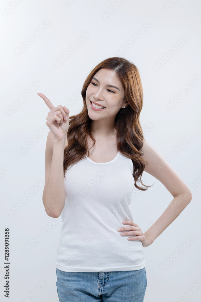 Isolated asian woman smiling and pointing to blank copy space Isolated asian woman smiling and pointing to blank copy space
