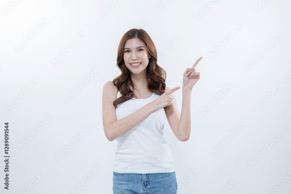 Isolated asian woman smiling and pointing to blank copy space Isolated asian woman smiling and pointing to blank copy space