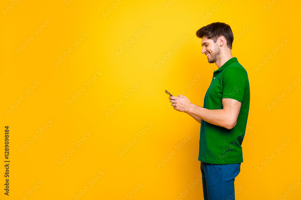 Profile side view portrait of his he nice attractive cheerful cheery addicted guy using digital device smm like isolated over bright vivid shine vibrant yellow color background Profile side view portrait of his he nice attractive cheerful cheery addicted guy using digital device smm like isolated over bright vivid shine vibrant yellow color background