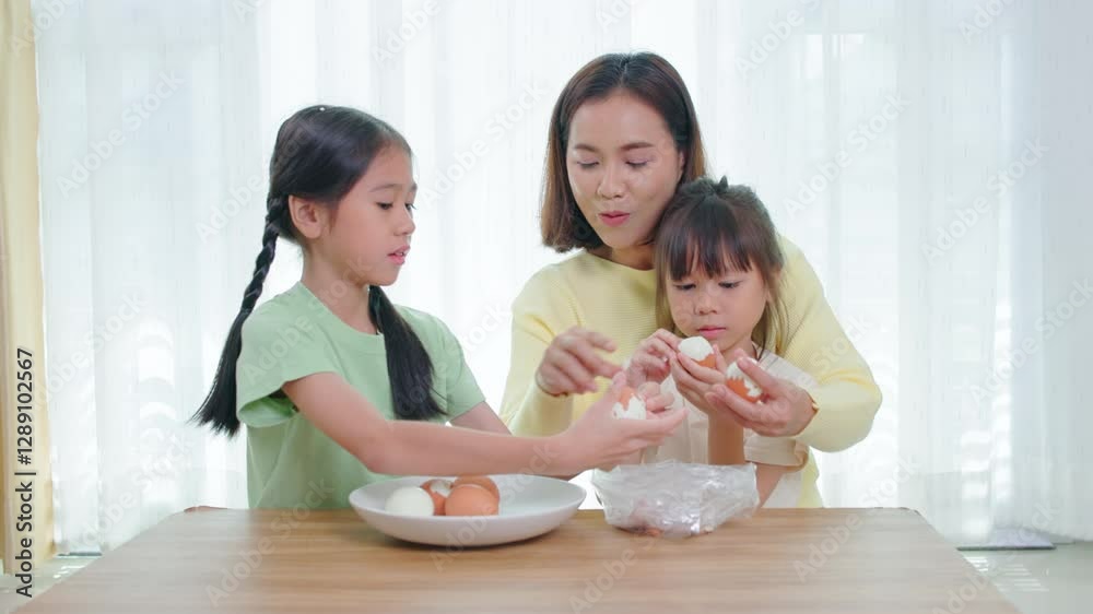 Happy family, father, mother and daughter are having fun playing hair styling game for daughter in living room Happy family, father, mother and daughter are having fun playing hair styling game for daughter in living room