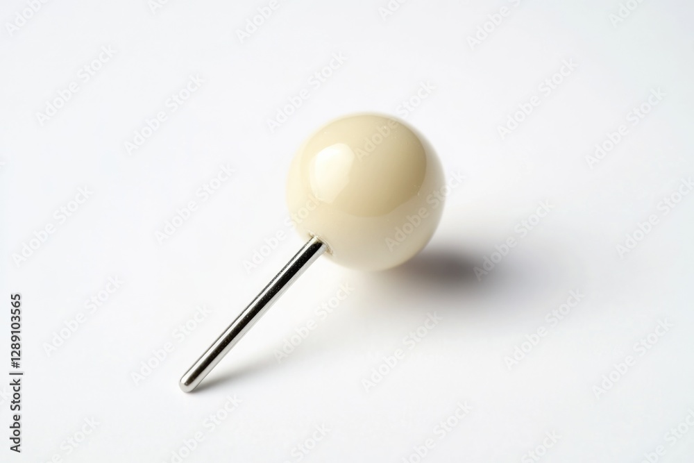 A simple setup featuring a white ball and a metal pin on a white background, suitable for various applications such as science experiments or product demonstrations A simple setup featuring a white ball and a metal pin on a white background, suitable for various applications such as science experiments or product demonstrations