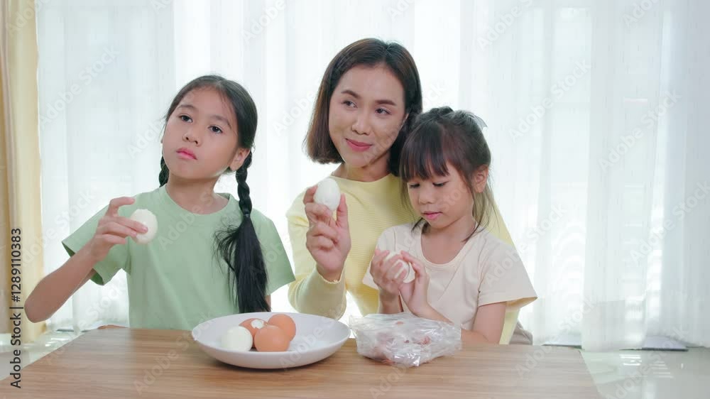 Happy family, father, mother and daughter are having fun playing hair styling game for daughter in living room Happy family, father, mother and daughter are having fun playing hair styling game for daughter in living room