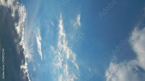 Wallpaper Mural Blue sky, sunlight and slowly moving white and grey clouds - natural sky background. Topics: cloudscape, sky space, weather, meteorology, season, air space, season Torontodigital.ca