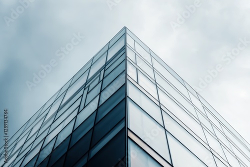 Intricate steel framework and reflective surfaces of a stunning high-rise building under a dramatic cloudy sky photo