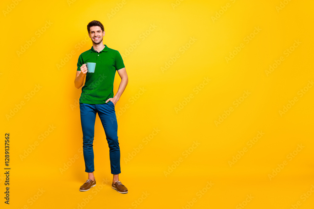 Fototapeta premium Full length body size view of his he nice attractive cheerful cheery content guy drinking coffee spending good day isolated over bright vivid shine vibrant yellow color background