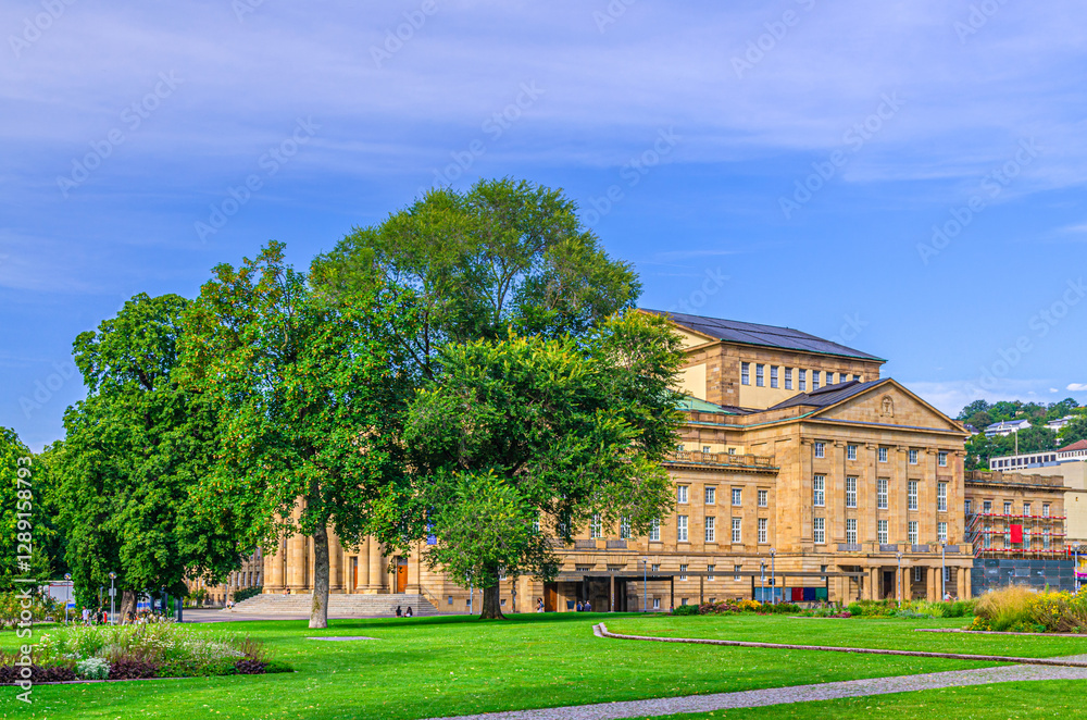 Obraz premium Staatstheater Stuttgart State Theatre, Staatsoper Stuttgart State Opera House and garden with green trees and grass lawn in old town Stuttgart city historic center, Baden-Württemberg state, Germany