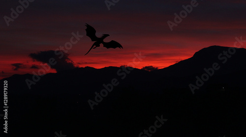 Dragon on red sky