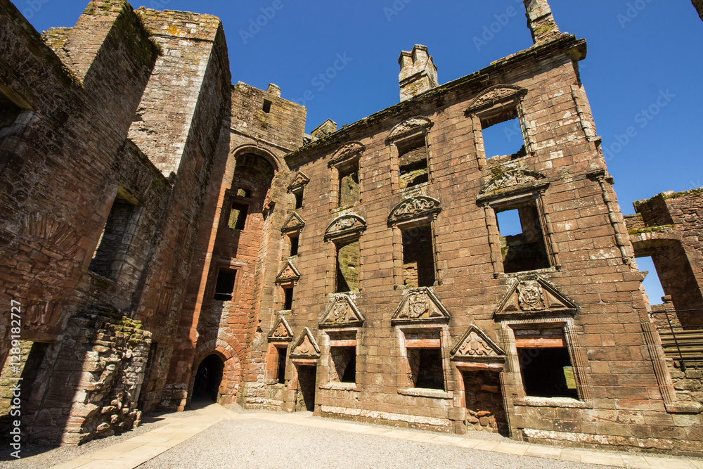 Fototapeta premium The remains of the Nithsdale Lodging within the ruins of Caerlaverock Castle in Scotland on a clear and sunny day.