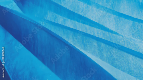 Abstract composition of fine ribbed blue paper texture with dynamic light and shadow play
