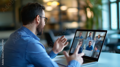 A focused corporate professional is participating in a virtual business meeting, speaking to colleagues through a laptop video call inside a modern office.remote business meeting,