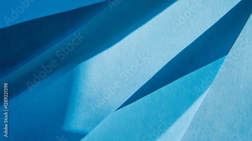 Abstract blue paper texture with sharp angular ribbed design for creative backgrounds