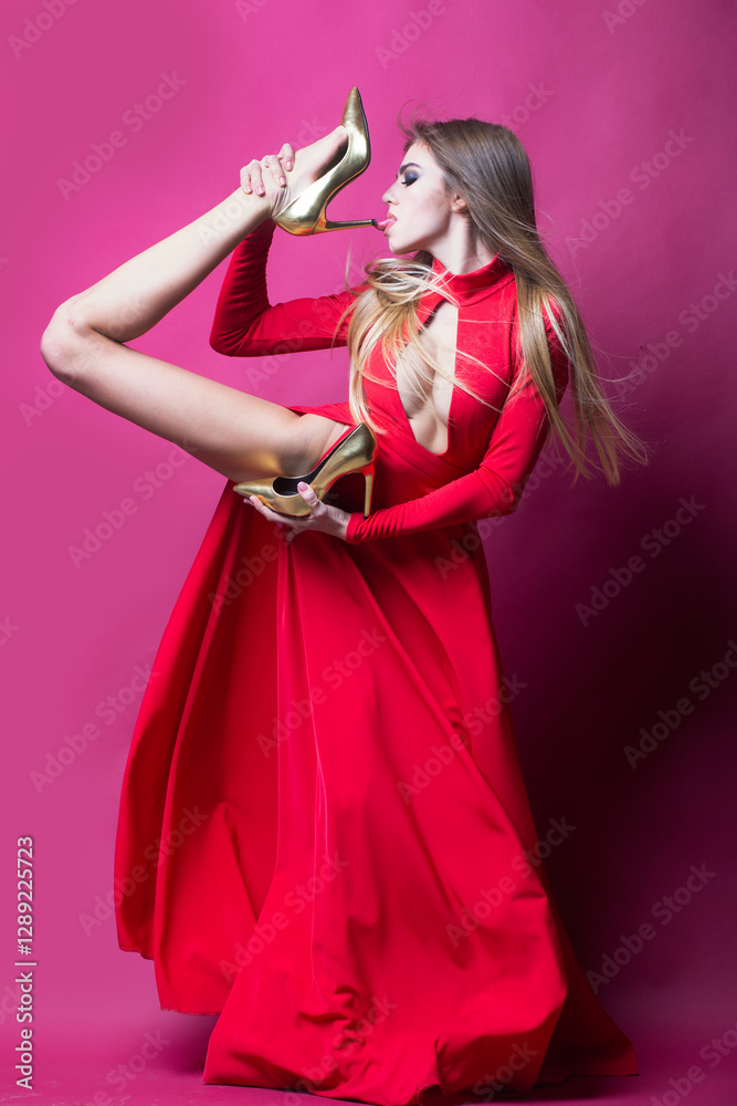 Obraz premium Sexy slim woman posing with High heels. Female sexy shoes. High heels, fashion shoe. Fashionable shoe store. Fashion model hold High heels. Trendy fashion high heeled shoes.