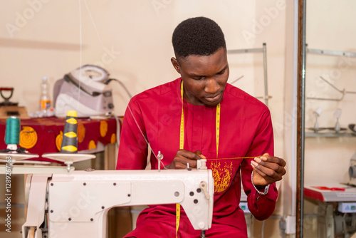 male african tailor sewing with her machine