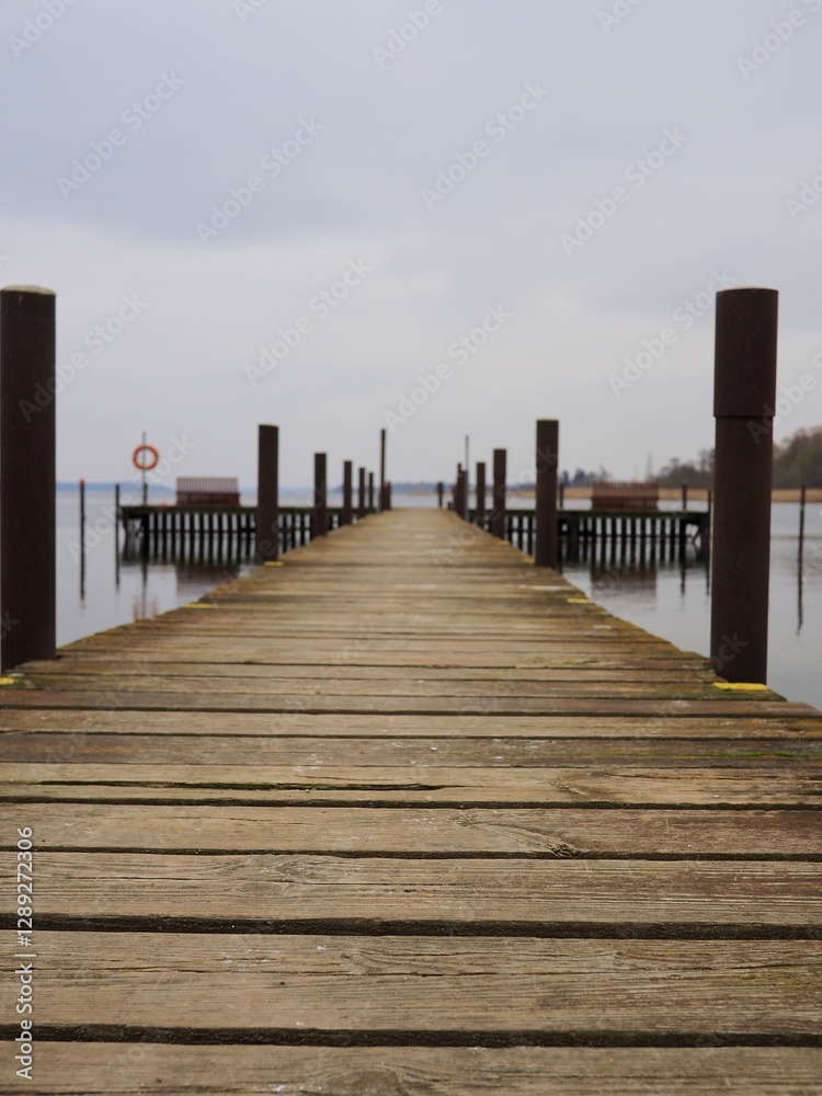 Fototapeta premium Empty wooden pier by calm water