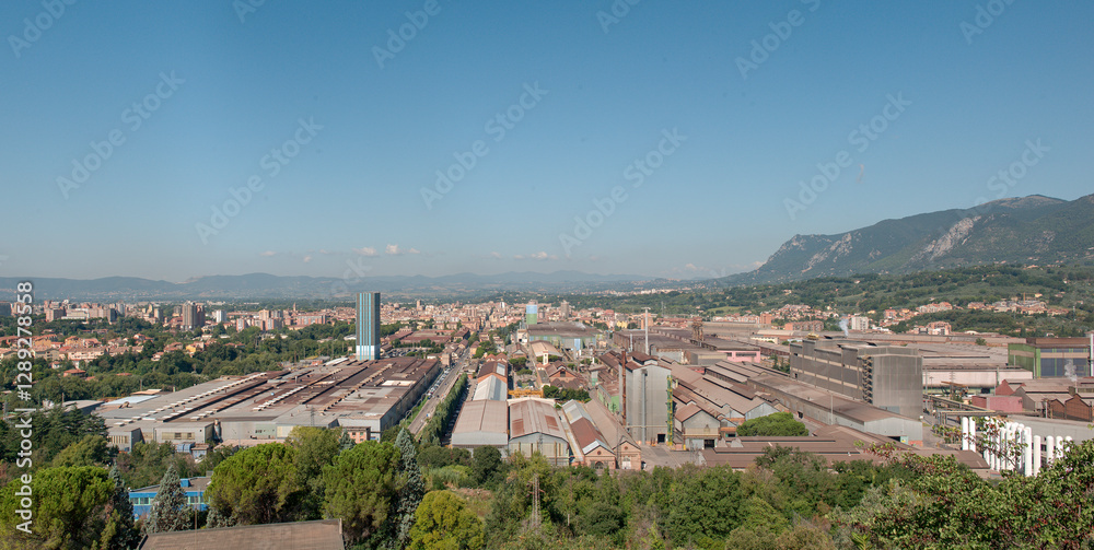Fototapeta premium Stitching panoramic view of the city of Terni in Italy with the steel mills in the foreground and the city in the background 