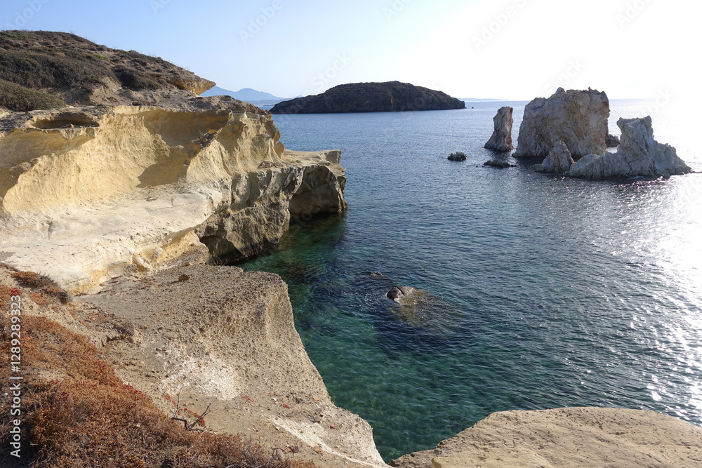 Obraz premium Paradise sandy organised beach of Mavrospilia with white rock formations best place to see the sunset in the island of Kimolos, Cyclades, Greece