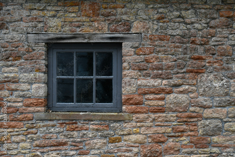 An old timber window in old brick wall An old timber window in old brick wall