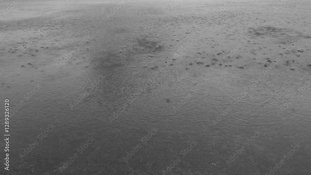 Slow motion of rain water splashing on concrete yard.Climate and weather,ecology and environment concept.Footage 4K Slow motion of rain water splashing on concrete yard.Climate and weather,ecology and environment concept.Footage 4K