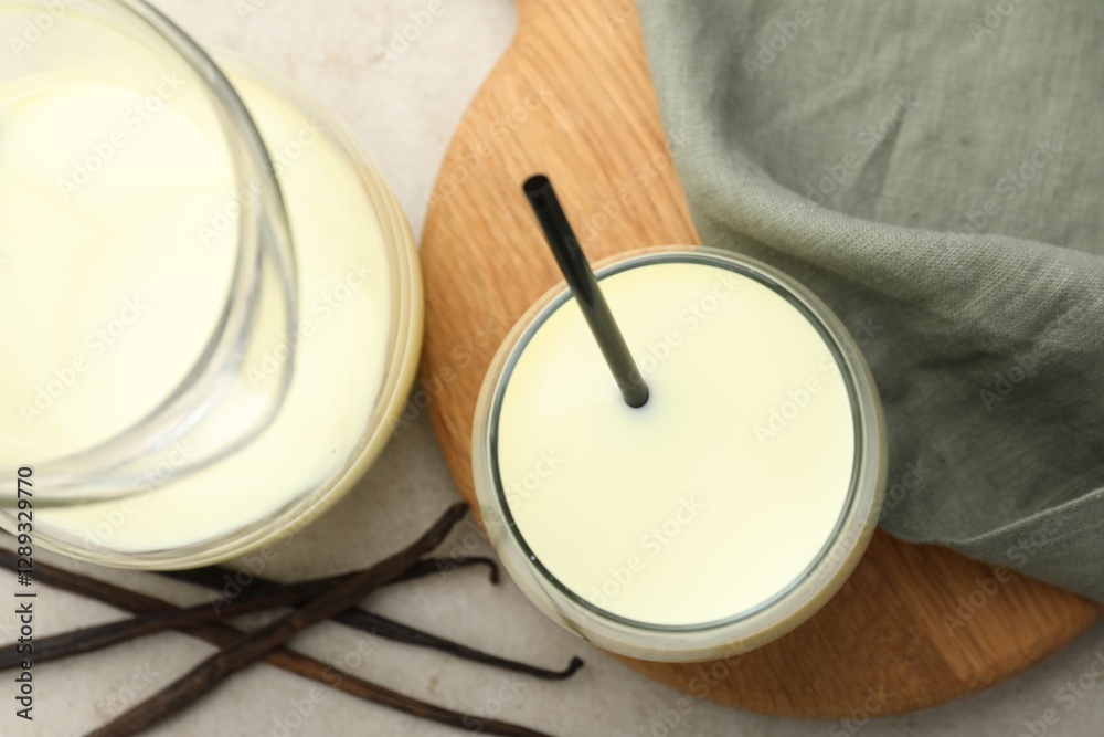 Delicious vanilla milk and pods on grey table, flat lay Delicious vanilla milk and pods on grey table, flat lay