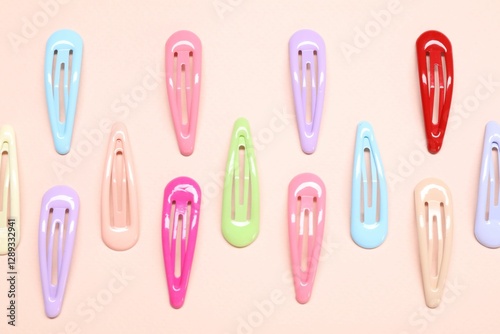 Colorful hair clips on light background, flat lay