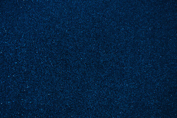 Shiny navy blue glitter texture background. Festive sparkly shiny wrapping paper background