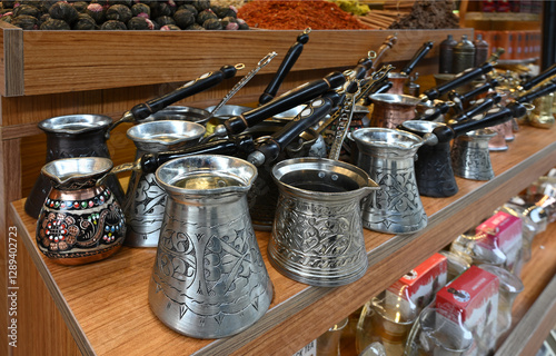 Different types of traditional Turkish coffee pots called cezve on a stall at a shop in stanbul Turkey photo