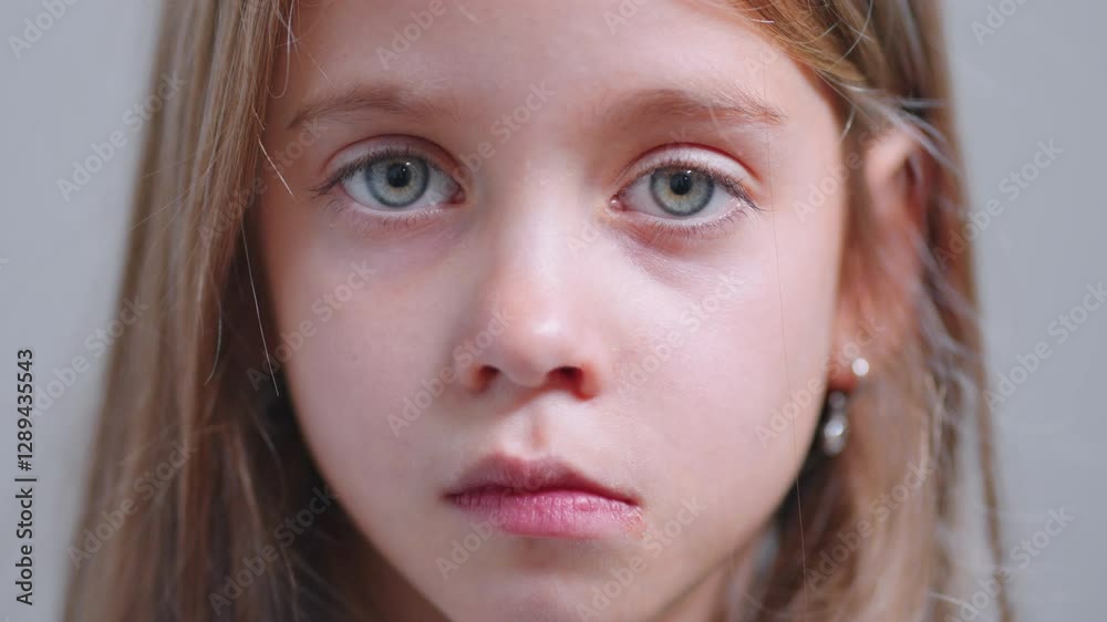 Little girl staring directly at the camera in a closeup portrait, highlighting her beautiful and expressive eyes, with a calm and focused expression Little girl staring directly at the camera in a closeup portrait, highlighting her beautiful and expressive eyes, with a calm and focused expression