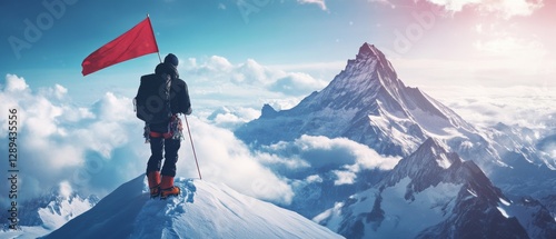 A climber stands triumphantly at a snowy mountain peak, holding a red flag against a backdrop of majestic, sunlit mountains and clouds. photo