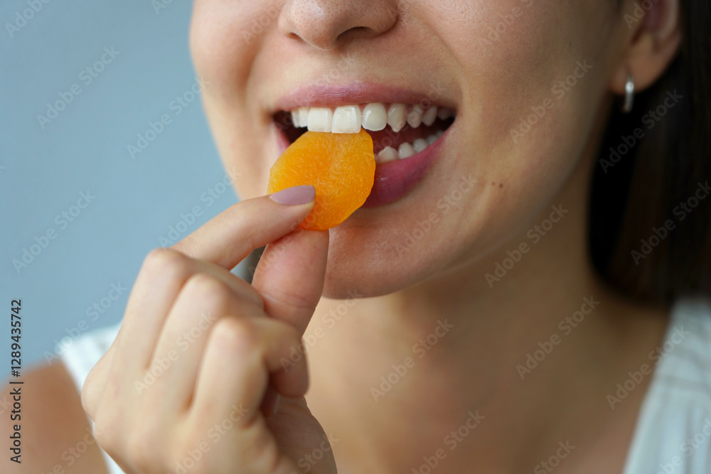 Apricot dried. Close-up of unidentified girl eating apricot fruit dried. Healthy food concept. Apricot dried. Close-up of unidentified girl eating apricot fruit dried. Healthy food concept.