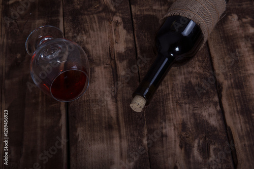 Wine bottles, glass on a wooden table