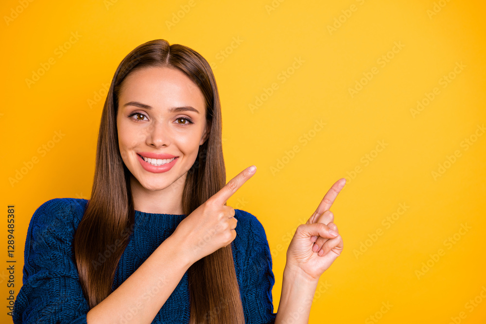 Close up photo of charming lady with long hairstyle pointing at copy space wearing maroon jumper isolated over yellow background Close up photo of charming lady with long hairstyle pointing at copy space wearing maroon jumper isolated over yellow background