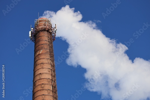 A smokestack emitting smoke from the top of a building, possibly industrial or residential.