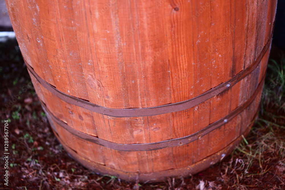 A single wooden barrel sits atop a green field. A single wooden barrel sits atop a green field.