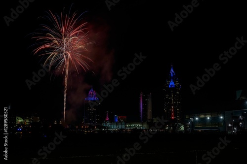 Red and gold fireworks bursting over a city skyline at night