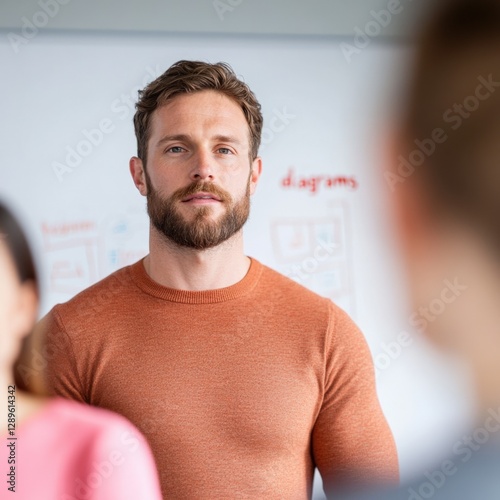 man presenting in front of a whiteboard