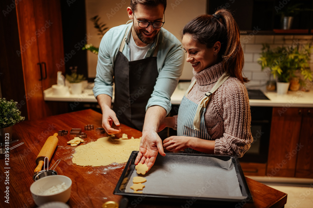 Couple enjoying baking cookies together at home Couple enjoying baking cookies together at home