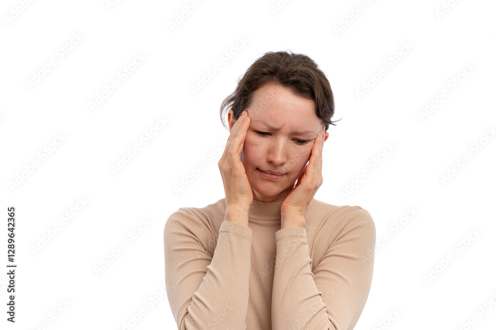 A young woman with a pained expression holding her head with both hands against a white background. A young woman with a pained expression holding her head with both hands against a white background.