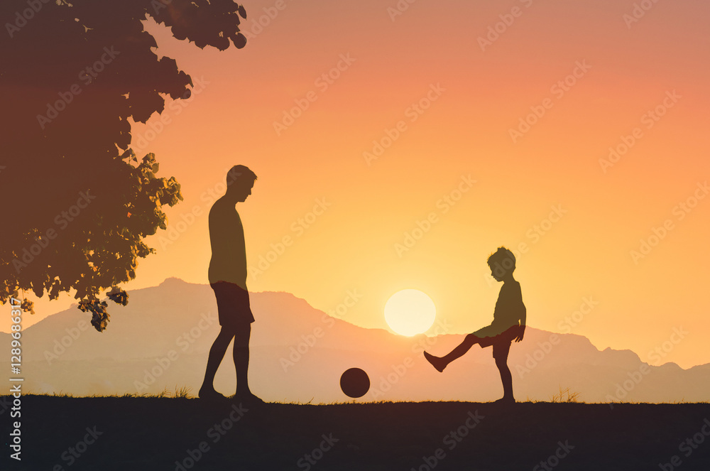 Father son playing in park kicking ball, child development, parent child relationship Father son playing in park kicking ball, child development, parent child relationship