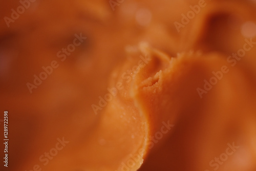 Close up of expired peanut butter texture. Eating rancid peanut butter can lead to tummy troubles like cramps, diarrhea or vomiting