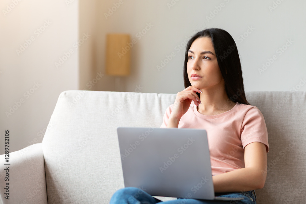 Pensive Freelancer Girl At Laptop Thinking Working Online Sitting On Couch At Home. Selective Focus, Empty Space Pensive Freelancer Girl At Laptop Thinking Working Online Sitting On Couch At Home. Selective Focus, Empty Space