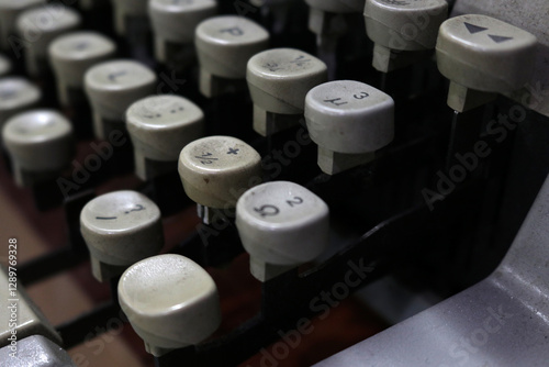 Photo of an ordinary old typewriter that is antique and dusty, used in the office