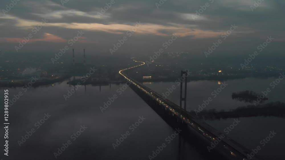 City at Twilight with a Busy Bridge, Heavy Traffic, and a Layer of Smog and Fog. Aerial View Capturing the Urban Atmosphere, Lights, and Hazy Evening Ambience.
City at Twilight with a Busy Bridge, Heavy Traffic, and a Layer of Smog and Fog. Aerial View Capturing the Urban Atmosphere, Lights, and Hazy Evening Ambience.